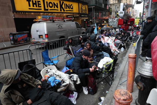 This photo taken on May 15, 2026, shows people camping out in line outside of the Swatch store in Times Square in New York, ahead of the May 16 release of the Audemars Piguet x Swatch Royal Pop watch. The collaboration between two Swiss watch brands, Swatch and Audemars Piguet, was highly anticipated by fans with some clients waiting for days ahead of the release. (Photo by TIMOTHY A. CLARY / AFP)