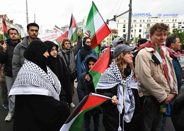 Participants waving Palestinian flags walk during a pro-Palestinian demonstration under the motto 'Song Protest Vienna 2026 - No Stage for Genocide' against Israel's participation in the Eurovision Song Contest (ESC), in Vienna, Austria, on May 16, 2026. (Photo by Joe Klamar / AFP)
