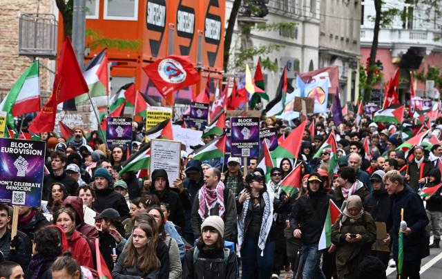 Participants wave banners reading "Block ESC" and various flags during a pro-Palestinian demonstration on the sidelines of the Eurovision Song Contest (ESC), in Vienna, Austria, on May 16, 2026. (Photo by Joe Klamar / AFP)
