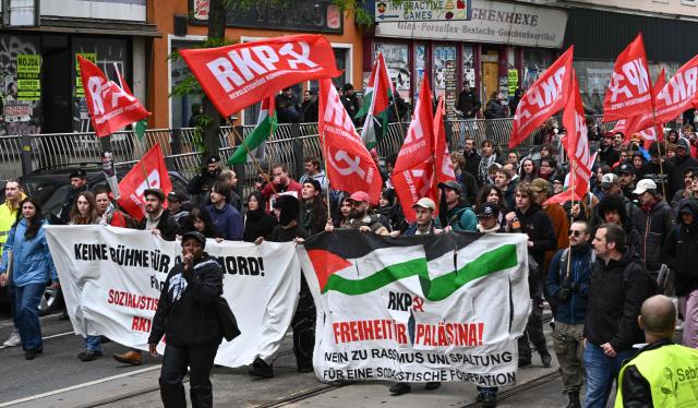 Participants wave banners and various flags during a pro-Palestinian demonstration on the sidelines of the Eurovision Song Contest (ESC), in Vienna, Austria, on May 16, 2026. (Photo by Joe Klamar / AFP)