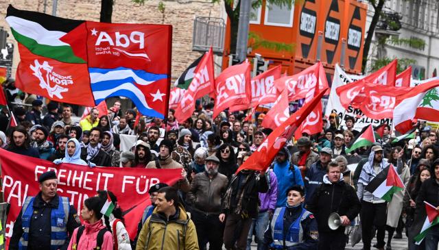 Participants wave banners and various flags during a pro-Palestinian demonstration on the sidelines of the Eurovision Song Contest (ESC), in Vienna, Austria, on May 16, 2026. (Photo by Joe Klamar / AFP)