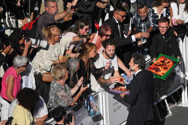 Spanish actor Javier Bardem signs autographs as he arrives for the screening of the film "El ser querido" (The Beloved) at the 79th edition of the Cannes Film Festival in Cannes, southern France on May 16, 2026. (Photo by Olivier CHASSIGNOLE / AFP)
