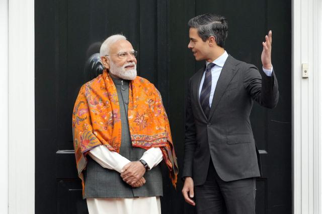 Indian Prime Minister Narendra Modi (L) is welcomed by Netherlands' Prime Minister Rob Jetten prior to a meeting as part of his official visiin The Hague on May 16, 2026. (Photo by Lina Selg / AFP)