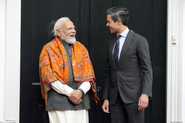 Indian Prime Minister Narendra Modi (L) is welcomed by Netherlands' Prime Minister Rob Jetten prior to a meeting as part of his official visiin The Hague on May 16, 2026. (Photo by Lina Selg / AFP)
