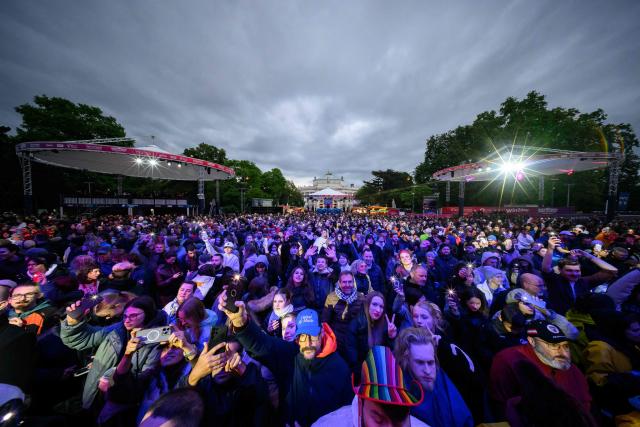 Fans celebrate in the fan area ahead the final of the Eurovision Song Contest 2026 (ESC) at Wiener Stadthalle in Vienna, Austria on May 16, 2026. (Photo by MAX SLOVENCIK / APA / AFP) / Austria OUT