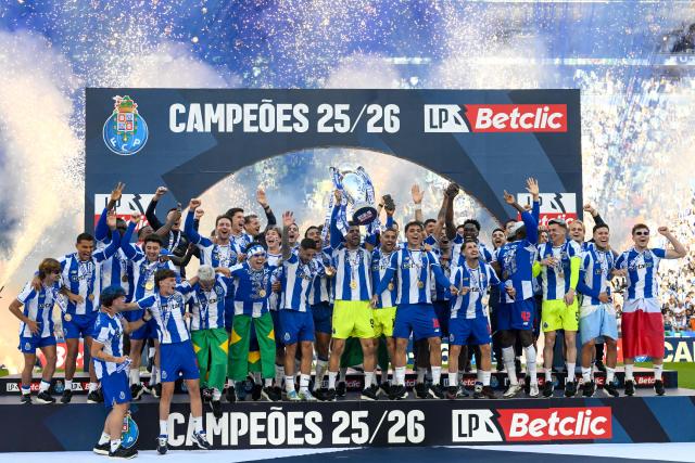 FC Porto players celebrate with the Portuguese League trophy after their Portuguese league match between FC Porto and CD Santa Clara at the Dragao stadium in Porto on May 16, 2026. (Photo by Miguel RIOPA / AFP)