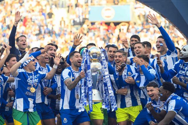 FC Porto players celebrate with the Portuguese League trophy after their Portuguese league match between FC Porto and CD Santa Clara at the Dragao stadium in Porto on May 16, 2026. (Photo by Miguel RIOPA / AFP)