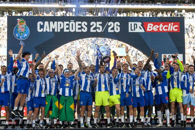 FC Porto players celebrate with the Portuguese League trophy after their Portuguese league match between FC Porto and CD Santa Clara at the Dragao stadium in Porto on May 16, 2026. (Photo by Miguel RIOPA / AFP)