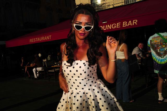 A woman wearing a sun dress poses on Place du General de Gaulle near the Palais des Festivals on the sidelines of the 79th edition of the Cannes Film Festival in Cannes, southern France on May 16, 2026. (Photo by VALERY HACHE / AFP)