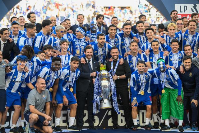 FC Porto's president Andre Villas-Boas (CL) and FC Porto's Italian coach Francesco Farioli (CR) hold the Portugues League trophy  after the Portuguese League football match between FC Porto and CD Santa Clara at the Dragao stadium in Porto on May 16, 2026. (Photo by Miguel RIOPA / AFP)