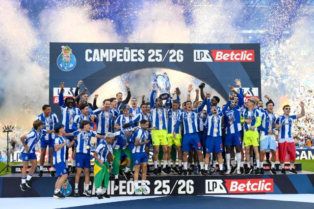 FC Porto players celebrate with the Portuguese League trophy after their Portuguese league match between FC Porto and CD Santa Clara at the Dragao stadium in Porto on May 16, 2026. (Photo by Miguel RIOPA / AFP)