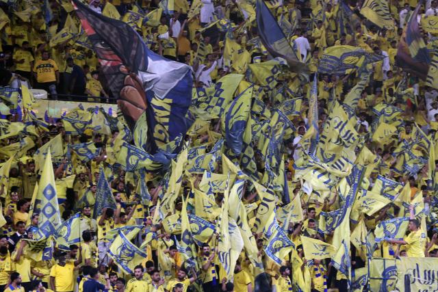 Fans of Nassr team wave flags before the start of the 2026 AFC Champions League Two final football match between Al-Nassr and Gamba Osaka at the Al-Awwal Park Stadium in Riyadh on May 16, 2026. (Photo by Fayez NURELDINE / AFP)