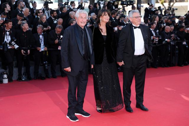 French director Claude Lelouch, French screenwriter Valerie Perrin and French producer Victor Hadida arrive for the screening of the film "El ser querido" (The Beloved) at the 79th edition of the Cannes Film Festival in Cannes, southern France on May 16, 2026. (Photo by Sameer AL-DOUMY / AFP)
