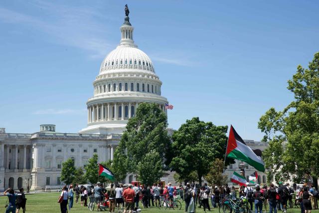 Demonstrators wave Palestinian flags as people gather near the US Capitol while participating in a Nakba solidarity bike ride from Dupont Circle to the US Capitol in Washington, DC, on May 16, 2026, marking the 78th anniversary of the Nakba. (Photo by Amid FARAHI / AFP)