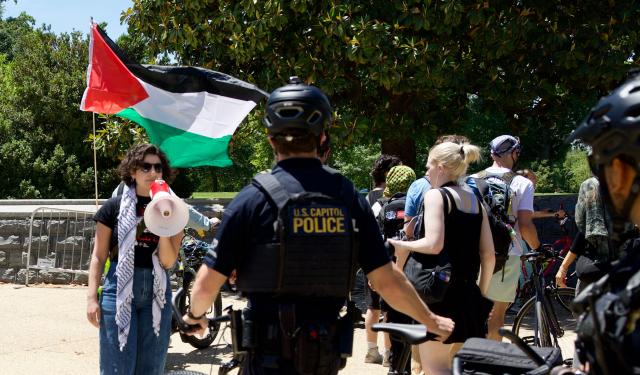 US Capitol police officers watch demonstrators gather near the US Capitol while participating in a Nakba solidarity bike ride from Dupont Circle to the US Capitol in Washington, DC, on May 16, 2026, marking the 78th anniversary of the Nakba. (Photo by Amid FARAHI / AFP)