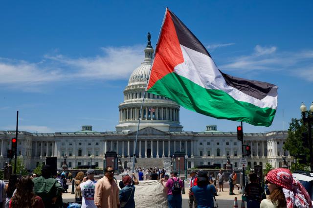 A demonstrator carries a Palestinian flag as people gather near the US Capitol while participating in a Nakba solidarity bike ride from Dupont Circle to the US Capitol in Washington, DC, on May 16, 2026, marking the 78th anniversary of the Nakba. (Photo by Amid FARAHI / AFP)
