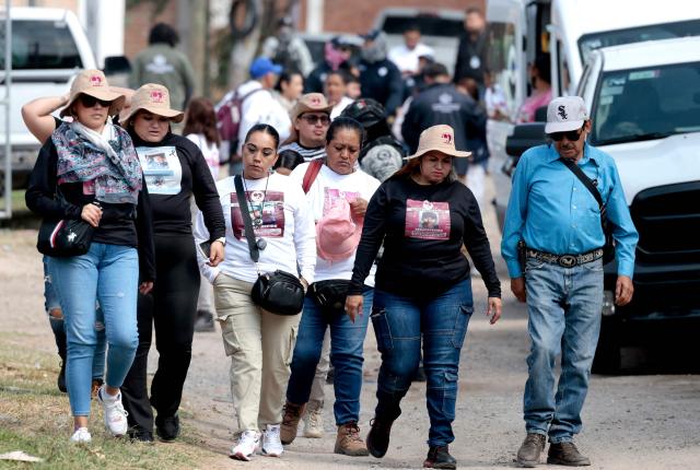 Cecilia Flores (2nd R), activist and founding member of the Madres Buscadoras de Sonora collective, walks with members of the Madres Buscadoras de Jalisco collective before entering the site of the Las Pintitas mass grave in El Salto, Jalisco state, Mexico, on May 16, 2026. (Photo by ULISES RUIZ / AFP)