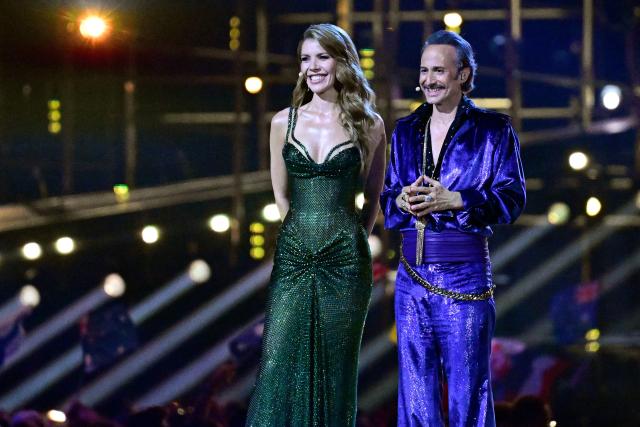 Austrian presenters Victoria Swarovski and Michael Ostrowski address the audience during the final of the Eurovision Song Contest 2026 (ESC) at Wiener Stadthalle in Vienna, Austria on May 16, 2026. (Photo by Tobias SCHWARZ / AFP)