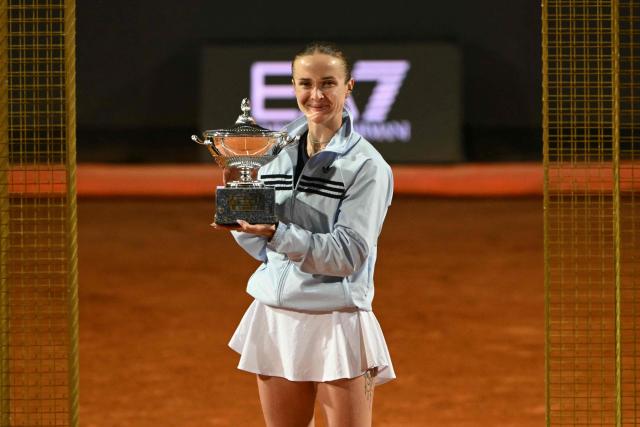 Ukraine's Elina Svitolina poses with the trophy after winning the WTA Rome Open tennis tournament final against USA's Coco Gauff at Foro Italico in Rome on May 16, 2026. (Photo by Andreas SOLARO / AFP)