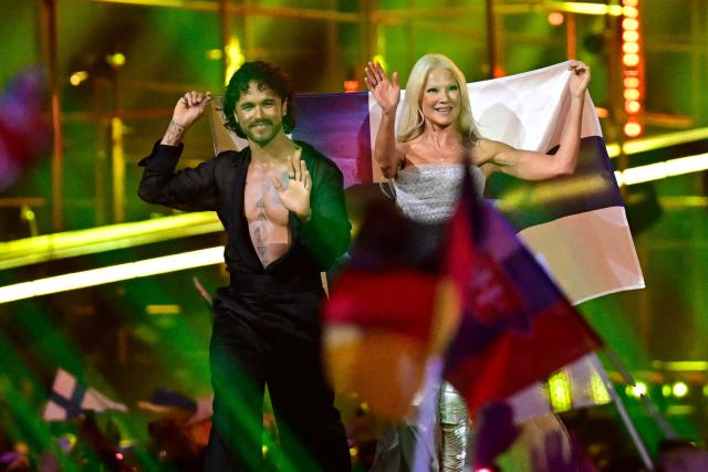 Finnish singers Linda Lampenius and Pete Parkkonen, representing Finland with the song 'Liekinheitin', arrives on stage during the final of the Eurovision Song Contest 2026 (ESC) at Wiener Stadthalle in Vienna, Austria on May 16, 2026. (Photo by Tobias SCHWARZ / AFP)
