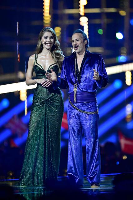 Austrian presenters Victoria Swarovski and Michael Ostrowski address the audience during the final of the Eurovision Song Contest 2026 (ESC) at Wiener Stadthalle in Vienna, Austria on May 16, 2026. (Photo by Tobias SCHWARZ / AFP)