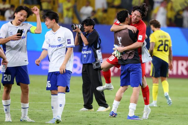 Gamba Osaka's players celebrate their win at the end of the 2026 AFC Champions League Two final football match between Al-Nassr and Gamba Osaka at the Al-Awwal Park Stadium in Riyadh on May 16, 2026. (Photo by Fayez NURELDINE / AFP)
