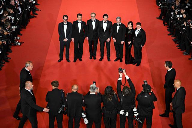(From L) Brazilian producer Rodrigo Teixeira, US actor Miles Teller, US director James Gray, US actor Adam Driver, US film producer Anthony Katagas, US producer Raffaella Leone and US editor Scott Morris arrive for the screening of the film "Paper Tiger" at the 79th edition of the Cannes Film Festival in Cannes, southern France on May 16, 2026. (Photo by Antonin THUILLIER / AFP)