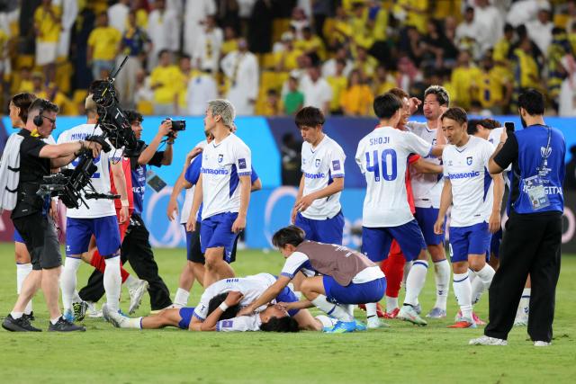Gamba Osaka's players celebrate their win at the end of the 2026 AFC Champions League Two final football match between Al-Nassr and Gamba Osaka at the Al-Awwal Park Stadium in Riyadh on May 16, 2026. (Photo by Fayez NURELDINE / AFP)
