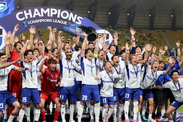 Gamba Osaka's players pose with the trophy after winning the 2026 AFC Champions League Two final football match between Al-Nassr and Gamba Osaka at the Al-Awwal Park Stadium in Riyadh on May 16, 2026. (Photo by Fayez NURELDINE / AFP)