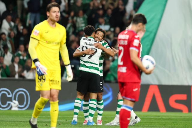Sporting Lisbon's Colombian forward #97 Luis Suarez celebrates scoring his team's second goal with Sporting Lisbon's Japanese midfielder #05 Hidemasa Morita during the Portuguese League football match between Sporting CP and Gil Vicente FC at the Jose Alvalade stadium in Lisbon on May 16, 2026. (Photo by PATRICIA DE MELO MOREIRA / AFP)