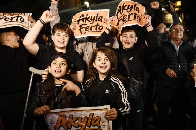 Supporters react as they watch on a giant screen the live performance of Greek singer Akylas Mytilinaios, known as Akylas, representing Greece with the song "Ferto" ("Bring It") in the final of the Eurovision Song Contest 2026 at the Wiener Stadthalle in Vienna, in Serres, northern Greece on May 16, 2026. (Photo by SAKIS MITROLIDIS / AFP)