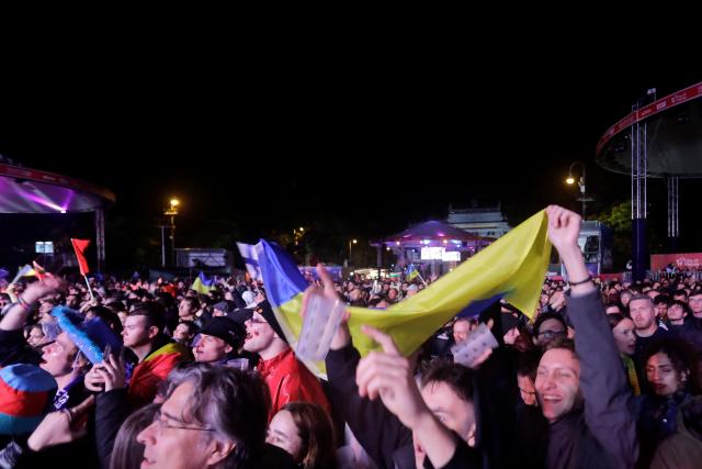 Spectators and fans react as they are gathered at the fan area to watch the final of the Eurovision Song Contest 2026 (ESC) outside the City Hall in Vienna, Austria on May 16, 2026. (Photo by Alex HALADA / AFP)