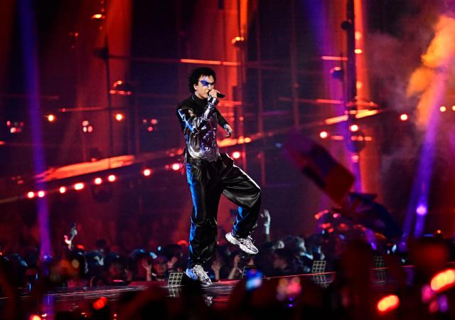 Austrian singer Benjamin Gedeon, aka Cosmo and representing Austria with the song 'Tanzschein', performs during the final of the Eurovision Song Contest 2026 (ESC) at Wiener Stadthalle in Vienna, Austria on May 16, 2026. (Photo by Tobias SCHWARZ / AFP)