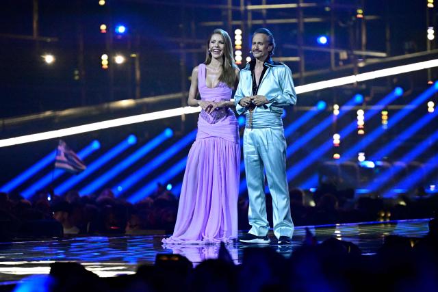 Austrian presenters Victoria Swarovski and Michael Ostrowski address the audience during the final of the Eurovision Song Contest 2026 (ESC) at Wiener Stadthalle in Vienna, Austria on May 16, 2026. (Photo by Tobias SCHWARZ / AFP)