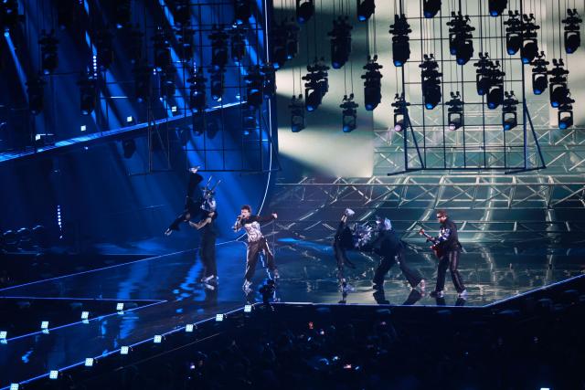 Austrian singer Benjamin Gedeon, aka Cosmo and representing Austria with the song 'Tanzschein', performs during the final of the Eurovision Song Contest 2026 (ESC) at Wiener Stadthalle in Vienna, Austria on May 16, 2026. (Photo by Radek MICA / AFP)