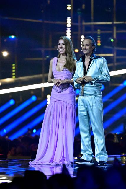 Austrian presenters Victoria Swarovski and Michael Ostrowski address the audience during the final of the Eurovision Song Contest 2026 (ESC) at Wiener Stadthalle in Vienna, Austria on May 16, 2026. (Photo by Tobias SCHWARZ / AFP)