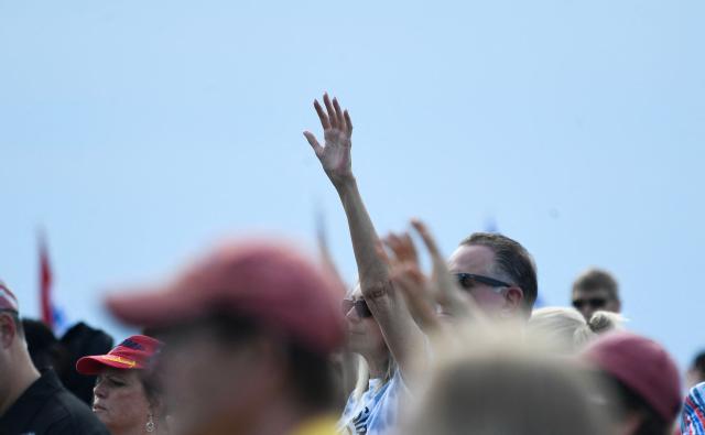 Christian worshipers raise their hands as faith leaders pray during the Roots of Revival event at the Washington Monument, held a day ahead of "Rededicate 250: A National Jubilee of Prayer, Praise and Thanksgiving" in Washington, DC, on May 16, 2026. (Photo by Matthew Hatcher / AFP)