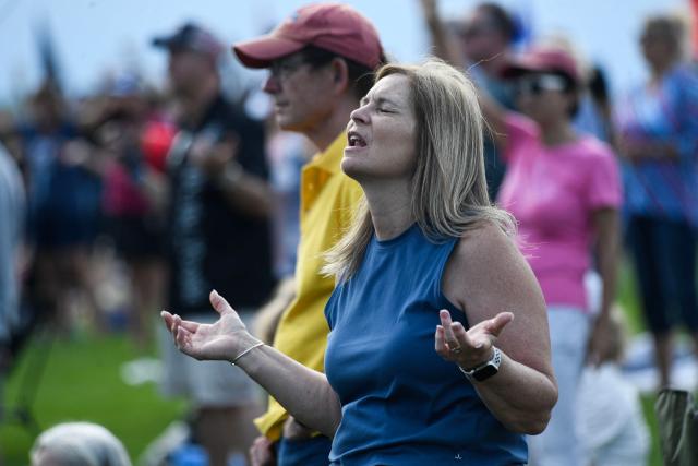 Christian worshipers raise their hands as faith leaders pray during the Roots of Revival event at the Washington Monument, held a day ahead of "Rededicate 250: A National Jubilee of Prayer, Praise and Thanksgiving" in Washington, DC, on May 16, 2026. (Photo by Matthew Hatcher / AFP)