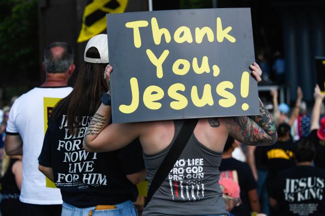 Christian worshipers listen to speakers and engage in prayer during the Roots of Revival event at the Washington Monument, held a day ahead of "Rededicate 250: A National Jubilee of Prayer, Praise and Thanksgiving" in Washington, DC, on May 16, 2026. (Photo by Matthew Hatcher / AFP)