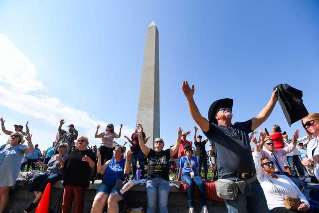Christian worshipers raise their hands as faith leaders pray during the Roots of Revival event at the Washington Monument, held a day ahead of "Rededicate 250: A National Jubilee of Prayer, Praise and Thanksgiving" in Washington, DC, on May 16, 2026. (Photo by Matthew Hatcher / AFP)