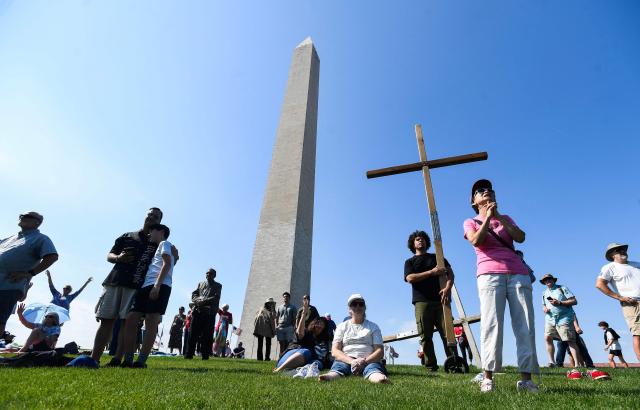 Christian worshipers attend the Roots of Revival event at the Washington Monument, held a day ahead of "Rededicate 250: A National Jubilee of Prayer, Praise and Thanksgiving" in Washington, DC, on May 16, 2026. (Photo by Matthew Hatcher / AFP)