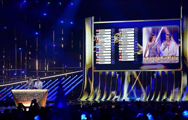 Austrian presenters Victoria Swarovski and Michael Ostrowski address the audience during the voting of the final of the Eurovision Song Contest 2026 (ESC) at Wiener Stadthalle in Vienna, Austria on May 16, 2026. (Photo by Tobias SCHWARZ / AFP)
