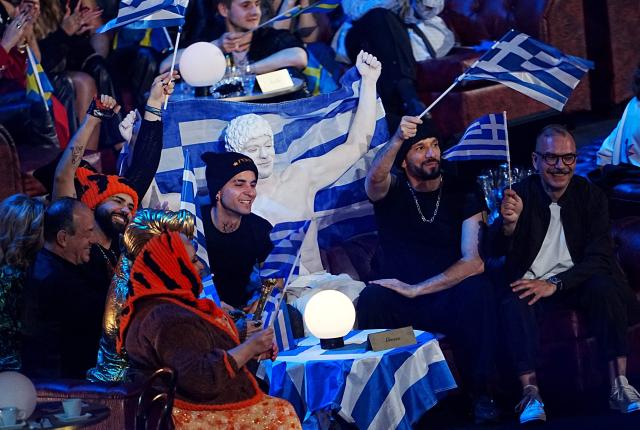 Greek singer Akylas Mytilinaios (L) reacts during the final of the Eurovision Song Contest 2026 (ESC) at Wiener Stadthalle in Vienna, Austria on May 16, 2026. (Photo by GEORG HOCHMUTH / APA / AFP) / Austria OUT