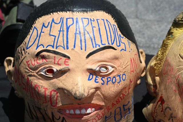 A soccer ball covered with a mask depicting Mexico's President Claudia Sheinbaum is pictured as activist from a feminist collective protest against the upcoming FIFA World Cup in Mexico City on May 16, 2026. (Photo by Yuri CORTEZ / AFP)