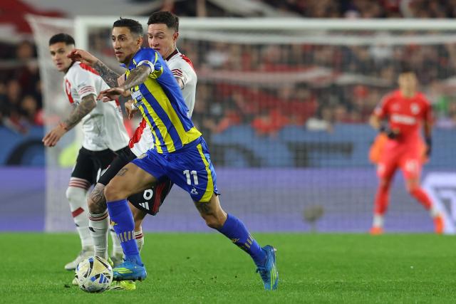 Rosario Central's forward #11 Angel Di Maria and River Plate's defender #06 Anibal Moreno fight for the ball during the Argentine Professional Football League Apertura tournament semifinal between River Plate and Rosario Central at MAS Monumental Stadium in Buenos Aires on May 16, 2026. (Photo by Alejandro PAGNI / AFP)
