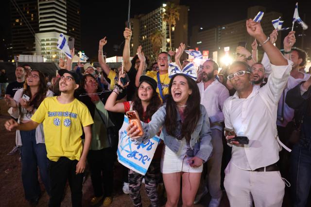 People cheer as they gather at the Tel Aviv 360, a giant beachfront stage in Tel Aviv on May 16, 2026, to watch the final of the Eurovision Song Contest 2026 (ESC) being held at the Wiener Stadthalle in Vienna, Austria. (Photo by Jack GUEZ / AFP)