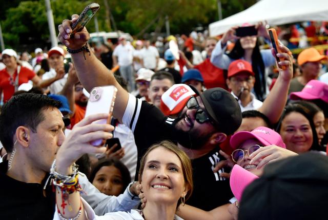 Colombia's right-wing presidential candidate Paloma Valencia, of the Centro Democratico party, takes a selfie with supporters during a campaign rally in Cucuta, Colombia on May 16, 2026. Colombia will hold presidential elections on May 31. (Photo by Schneyder Mendoza / AFP)