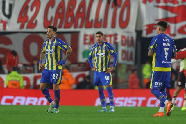Rosario Central's forward #22 Enzo Copetti (L) and forward #18 Julian Fernandez (C) react at the end of the Argentine Professional Football League Apertura tournament semifinal between River Plate and Rosario Central at MAS Monumental Stadium in Buenos Aires on May 16, 2026.  (Photo by Alejandro PAGNI / AFP)