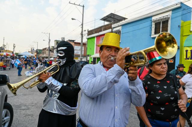 Musicians attend a rally to celebrate the end of the term of Attorney General Consuelo Porras on the outskirts of the Public Ministry headquarters in Guatemala City on May 16, 2026. The Attorney General of Guatemala, Consuelo Porras, sanctioned by 40 countries and considered the most powerful woman in the country, is leaving office after eight years, which nevertheless does not dispel the shadow of corruption over the justice system. (Photo by Johan ORDONEZ / AFP)