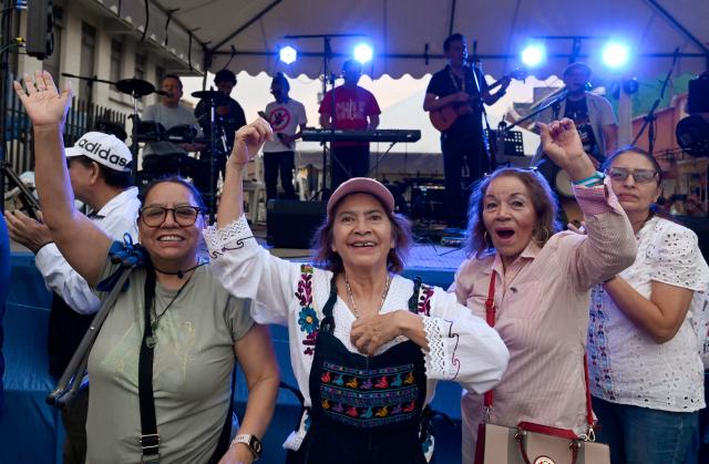 People attend a rally to celebrate the end of the term of Attorney General Consuelo Porras on the outskirts of the Public Ministry headquarters in Guatemala City on May 16, 2026. The Attorney General of Guatemala, Consuelo Porras, sanctioned by 40 countries and considered the most powerful woman in the country, is leaving office after eight years, which nevertheless does not dispel the shadow of corruption over the justice system. (Photo by Johan ORDONEZ / AFP)